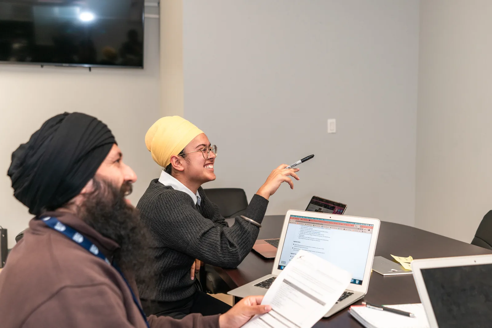 A professional team of colleagues engaging in a meeting, fostering teamwork and collaboration.